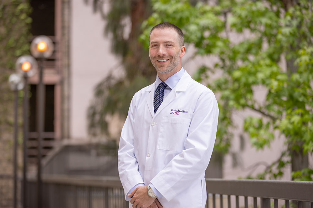 A portrait of Dr. Stuart Abel standing in a white coat outside.